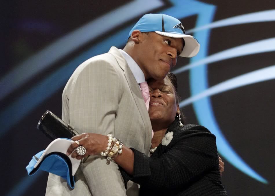 92964-quarterback-newton-of-auburn-university-is-hugged-by-his-mother-jackie.jpg
